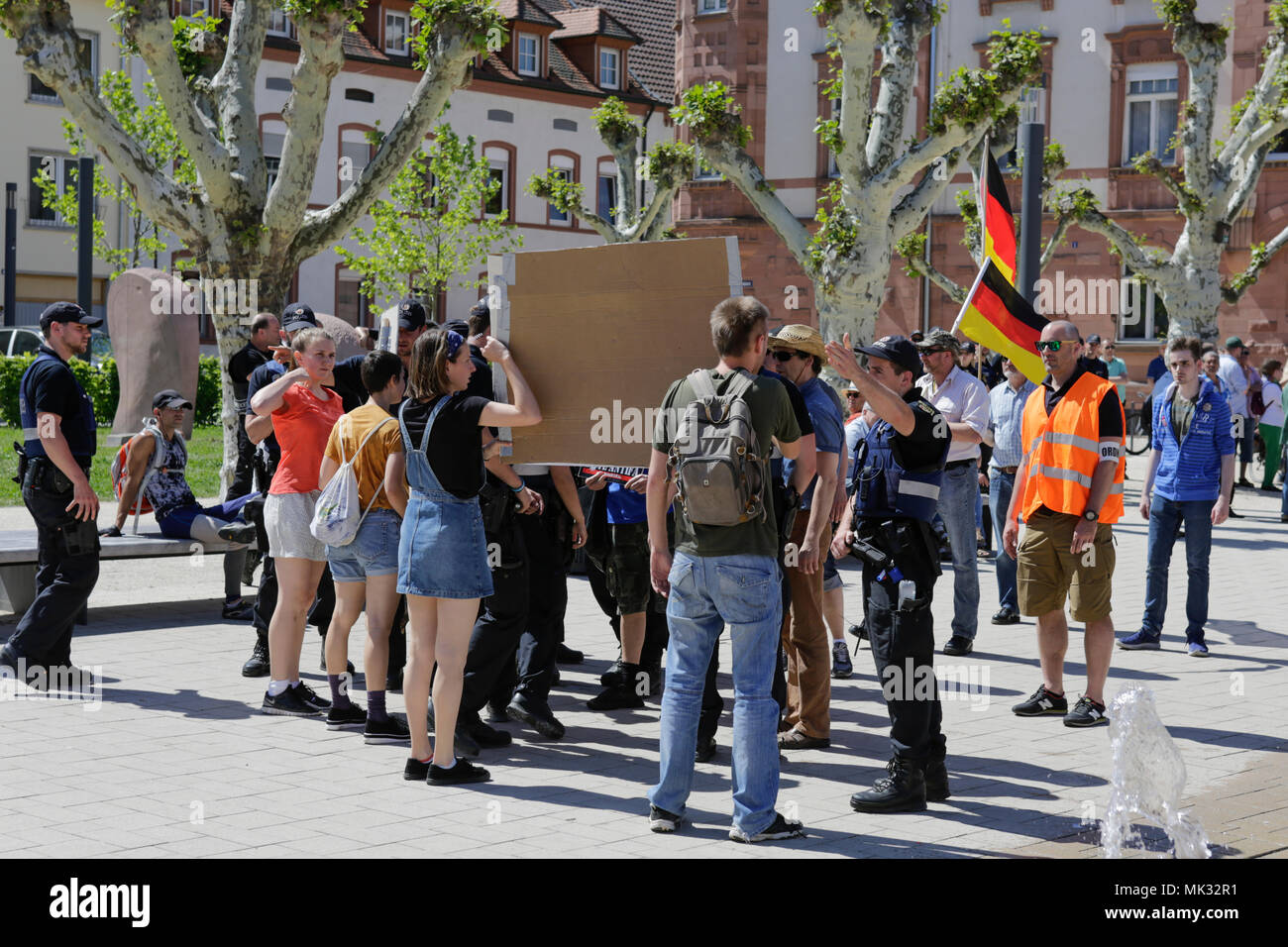 Germersheim, Germany. 6th May 2018. Police officers push back counter-protesters. Around 100 from different right-wing organisations protested in the city of Germersheim against Angela Merkel and for the security of women and children, which they see at risk by refugees and foreigners. They also called for the introduction of mandatory age checks (DNA test) by underage refugees. Credit: Michael Debets/Alamy Live News Stock Photo