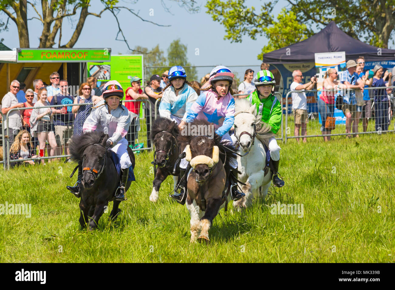 Netley Marsh, Hampshire, UK. 6th May 2018. The first day, of the two day event, Hampshire Game & Country Fair attracts the crowds on a hot sunny day. Young jockeys take part in the Shetland Pony racing and thrill the crowds. Credit: Carolyn Jenkins/Alamy Live News Stock Photo