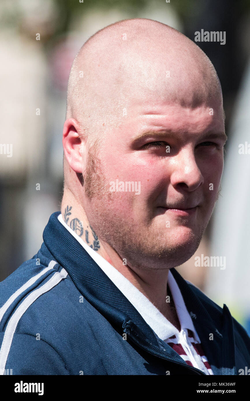 London, UK. 6th May, 2018. A supporter of the far-right Democratic Football Lads Alliance observes anti-racist and anti-fascist groups holding a counter-protest to the DFLA's 'Day of Freedom' event in Whitehall at which former English Defence League leader Tommy Robinson was scheduled to speak. Credit: Mark Kerrison/Alamy Live News Stock Photo