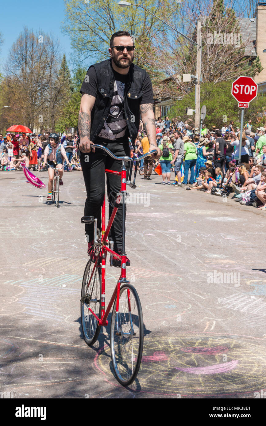 MINNEAPOLIS - May 6, 2018: A man rides a homemade double-decker bicycle in Minneapolis’ yearly May Day parade. Organized by In the Heart of the Beast Puppet and Mask Theatre, the parade, ceremony, and festival is in its 44th year. Credit: Nicholas Neufeld/Alamy Live News Stock Photo