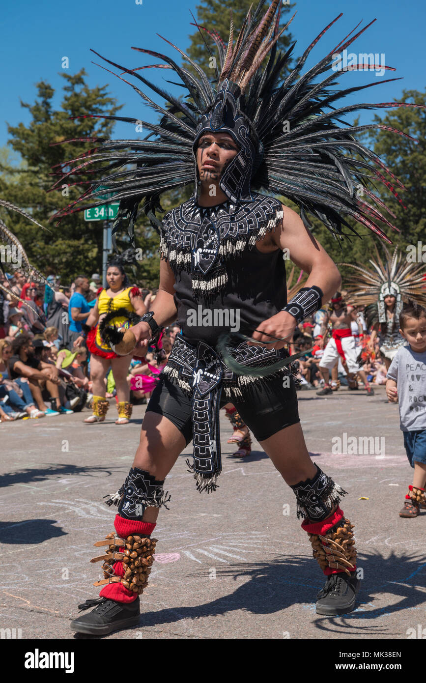 MINNEAPOLIS - May 6, 2018: A man in traditional Aztec dress dances in Minneapolis’ yearly May Day parade. Organized by In the Heart of the Beast Puppet and Mask Theatre, the parade, ceremony, and festival is in its 44th year. Credit: Nicholas Neufeld/Alamy Live News Stock Photo