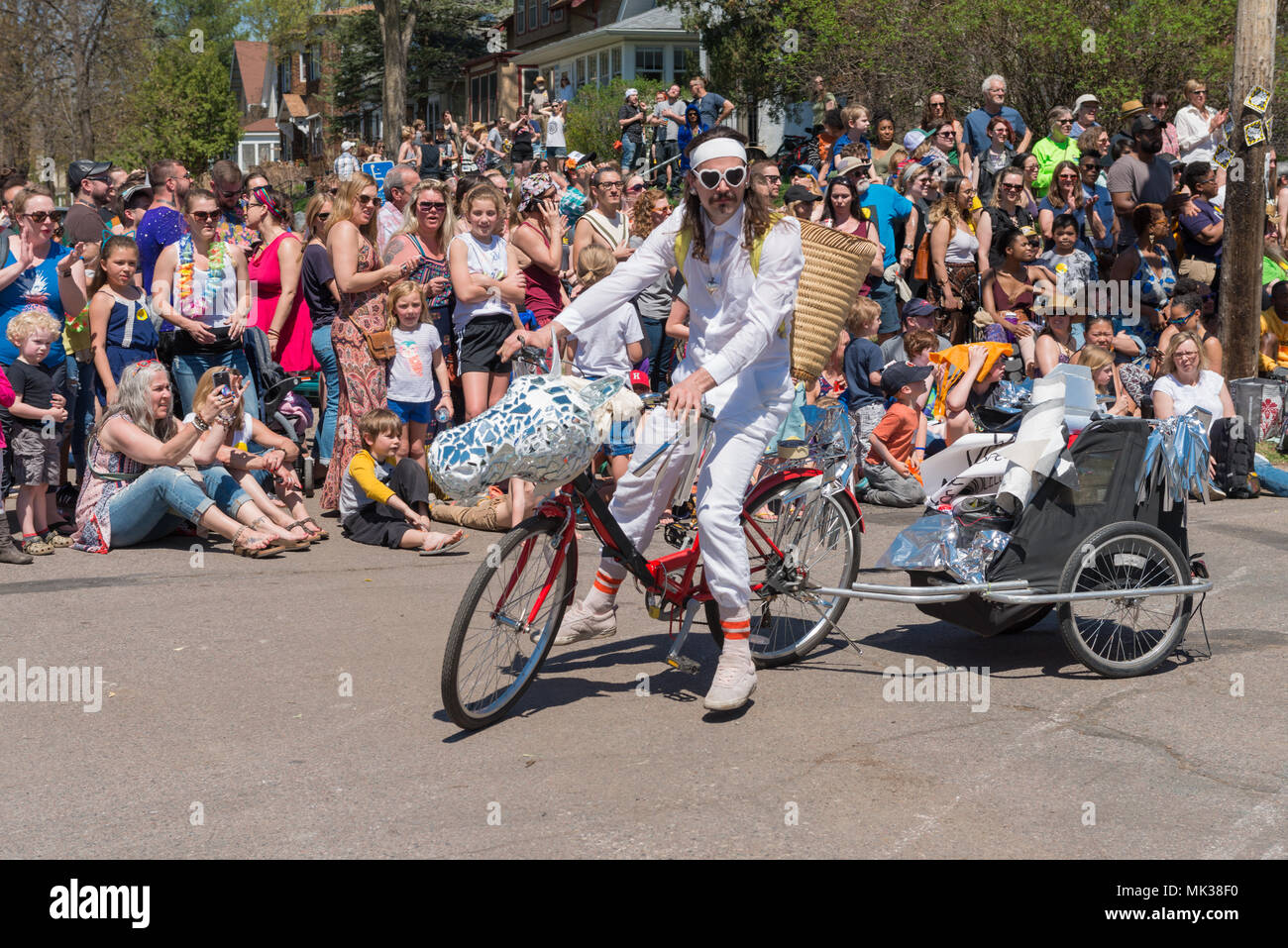 MINNEAPOLIS - May 6, 2018: A man has transformed his bicycle into a shiny unicorn for Minneapolis’ yearly May Day parade. Organized by In the Heart of the Beast Puppet and Mask Theatre, the parade, ceremony, and festival is in its 44th year. Credit: Nicholas Neufeld/Alamy Live News Stock Photo