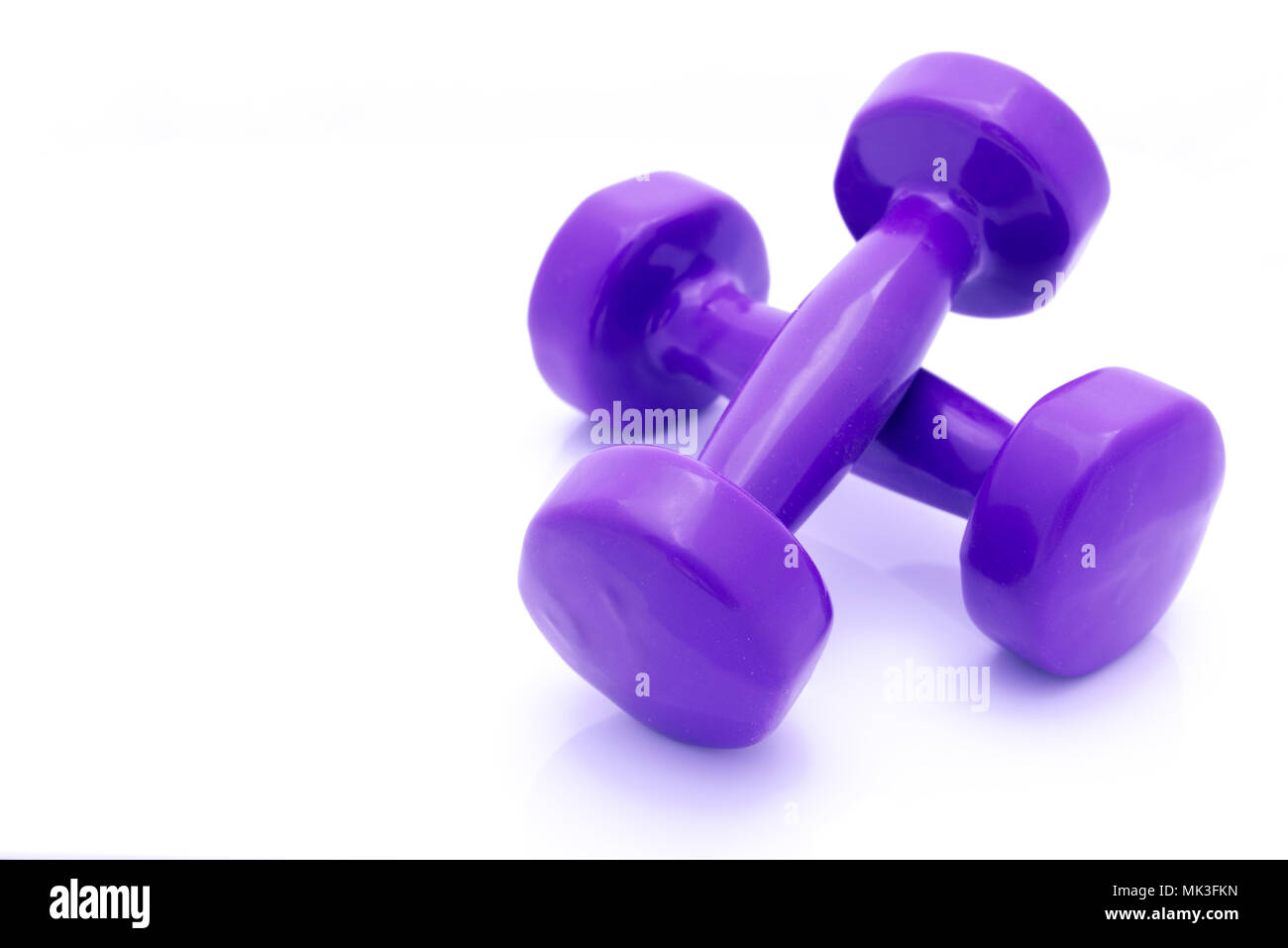Colourful hand weights isolated on a white background with copy space ...