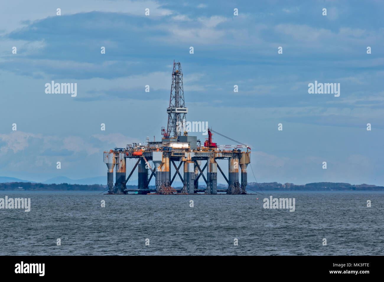 CROMARTY FIRTH SCOTLAND DECOMMISSIONED  OIL RIG LYING OFF THE TOWN OF INVERGORDON Stock Photo