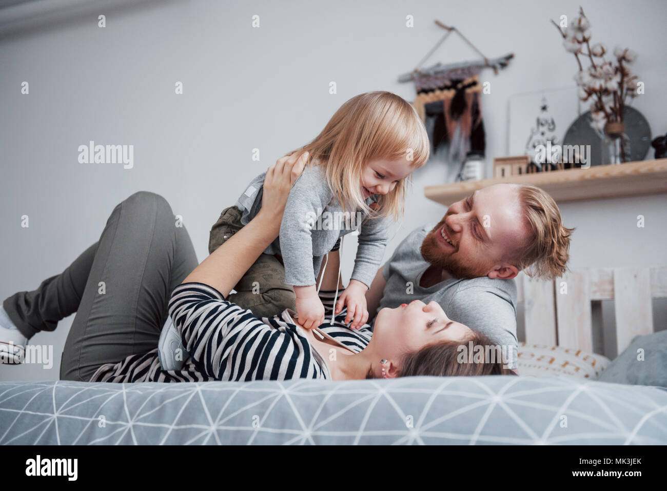 happy family mother, father and child daughter laughs in bed Stock ...