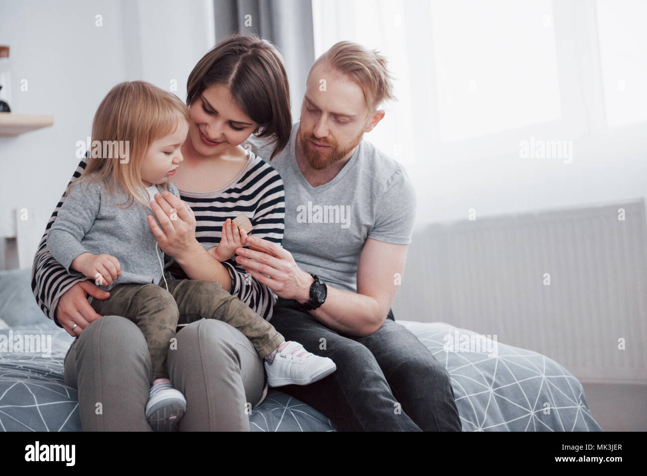 happy family mother, father and child daughter laughs in bed Stock ...