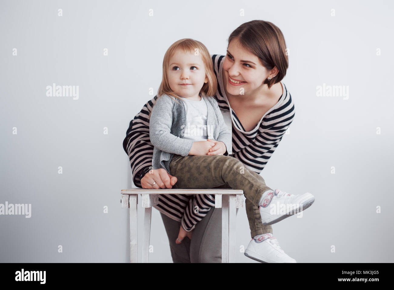 Happy loving family. Mother and her daughter child girl playing and hugging Stock Photo