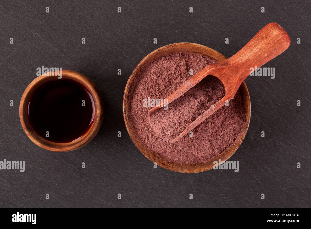 Ayahuasca brew and powdered mimosa tenuiflora in wooden bowls from above. Mimohuasca. Stock Photo