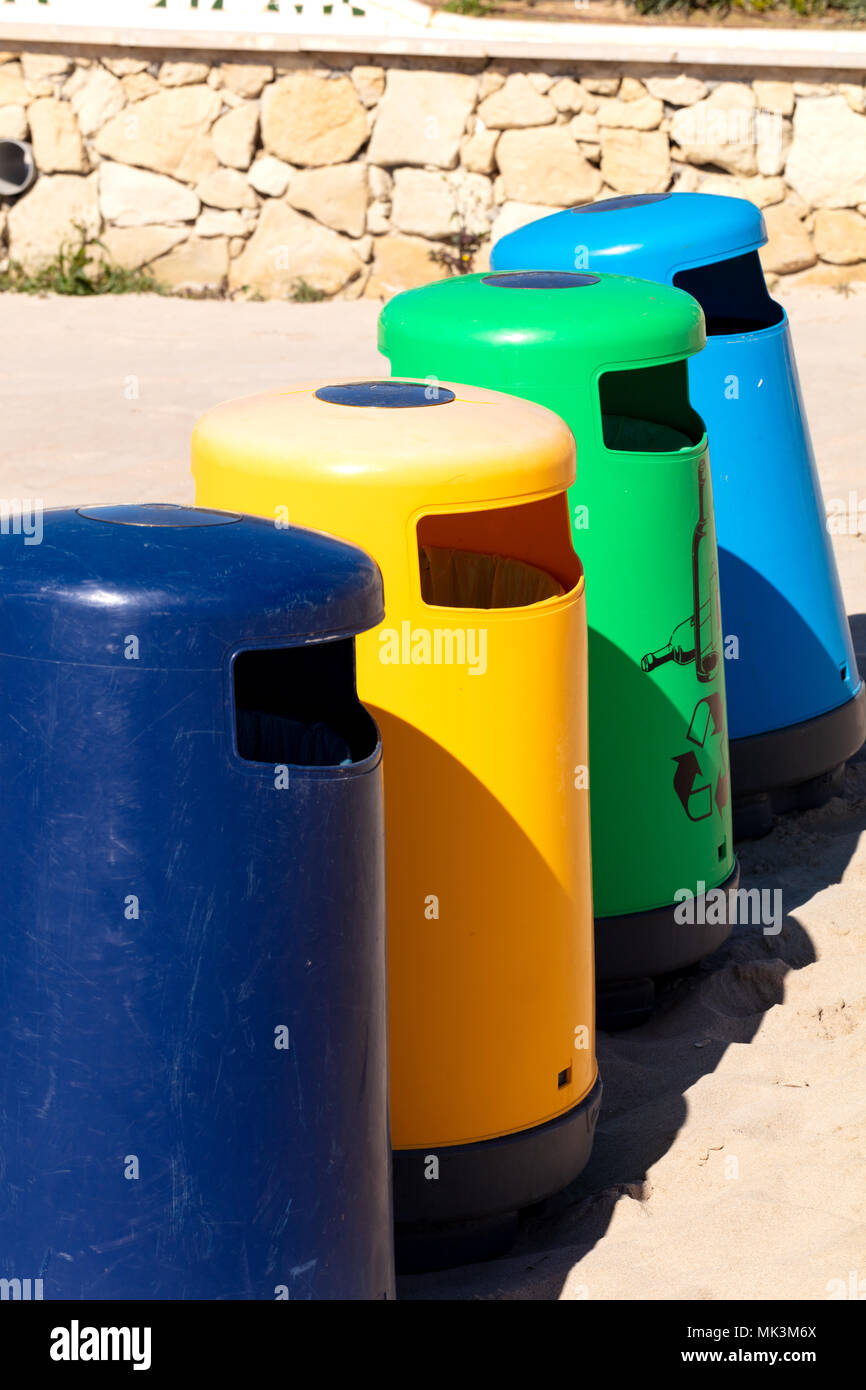 https://c8.alamy.com/comp/MK3M6X/selective-recicle-bins-with-different-colors-in-a-mediterranean-beach-MK3M6X.jpg