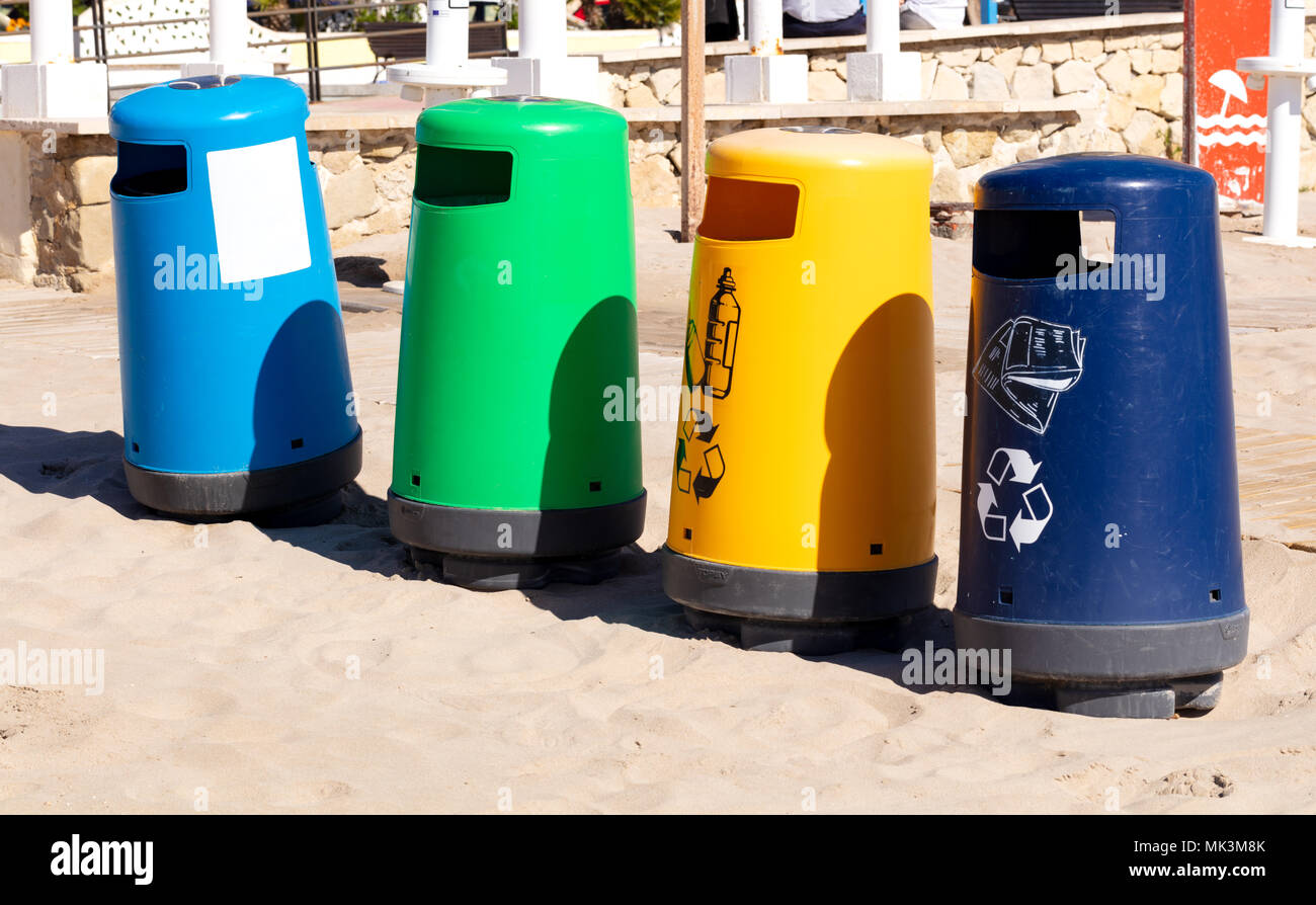 selective recicle bins with different colors in a mediterranean beach Stock Photo