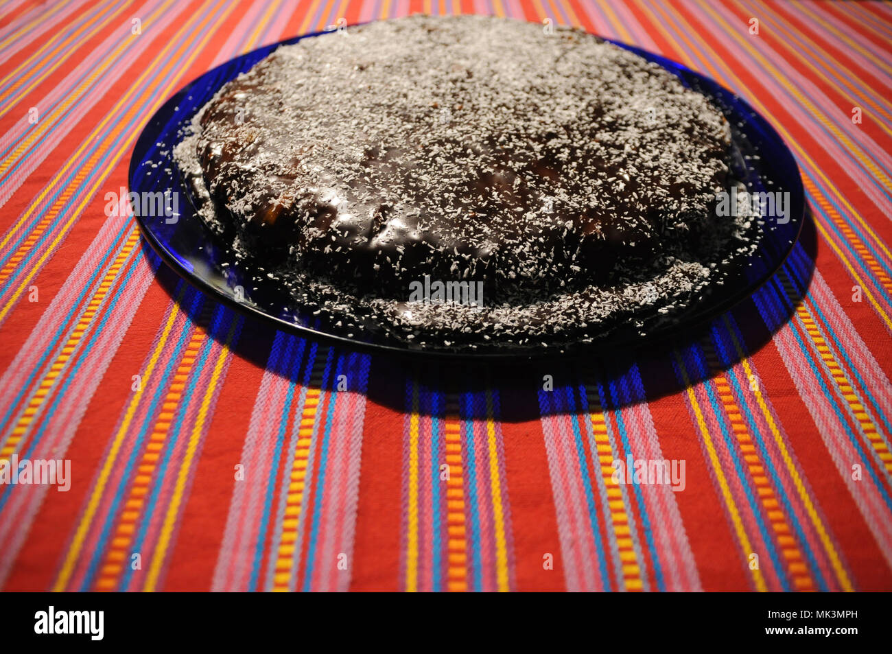 Homemade cake on a colorful table. Chocolate cake with cocos respells Stock Photo