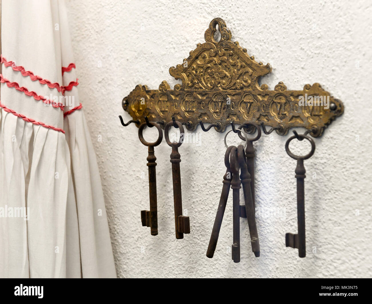 Old bunch of keys hanging on a  wall, Germany Stock Photo