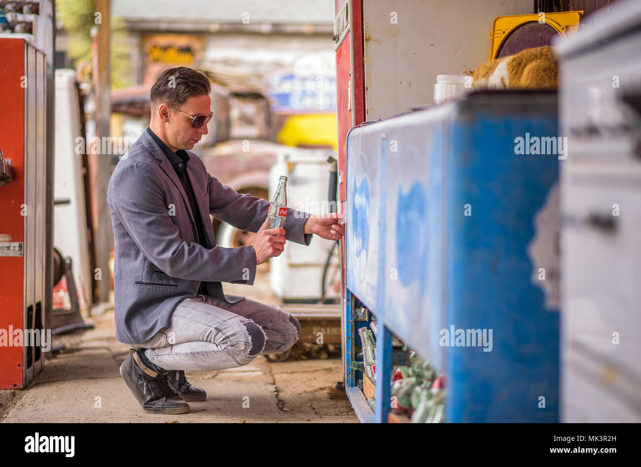 Man with an empty Coca Cola bottle  at a vintage vending machine Stock Photo