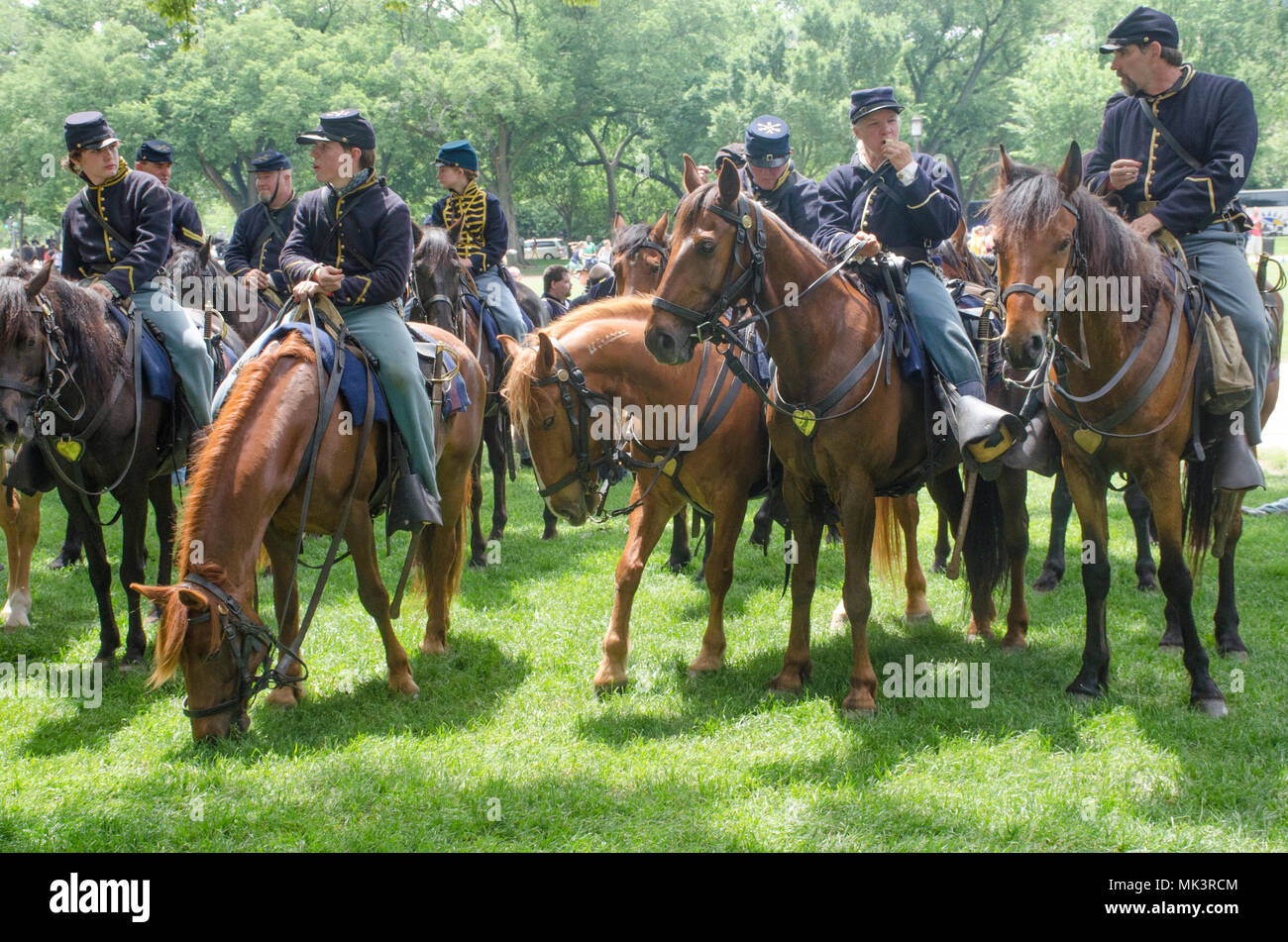 Civil War reenacotrs and their horse snack on the National Mall in Washington, DC. The gathering marked the 150th anniversary of the grand parade cele Stock Photo