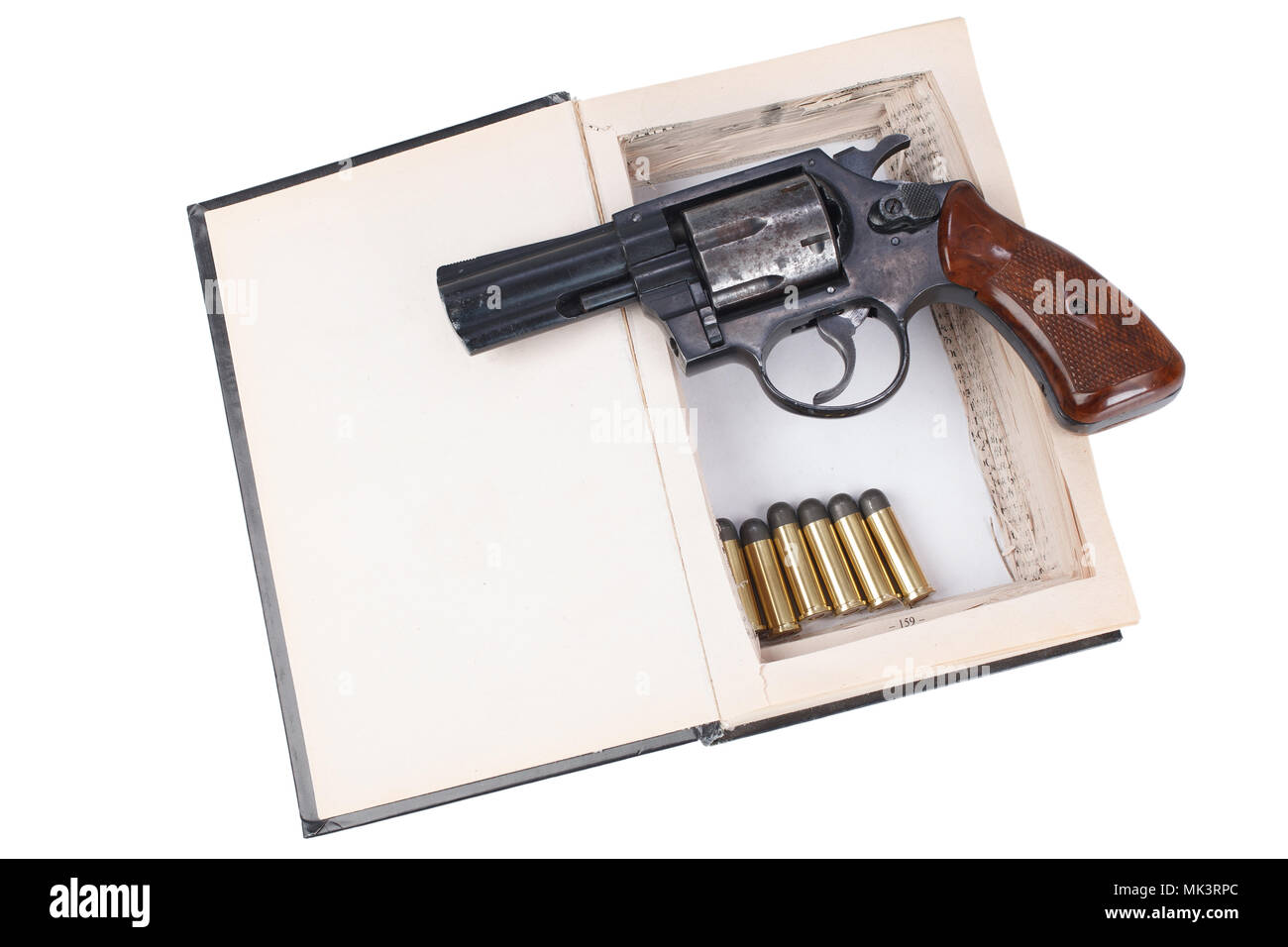 Revolver gun with cartridges hidden in a book isolated on white ...