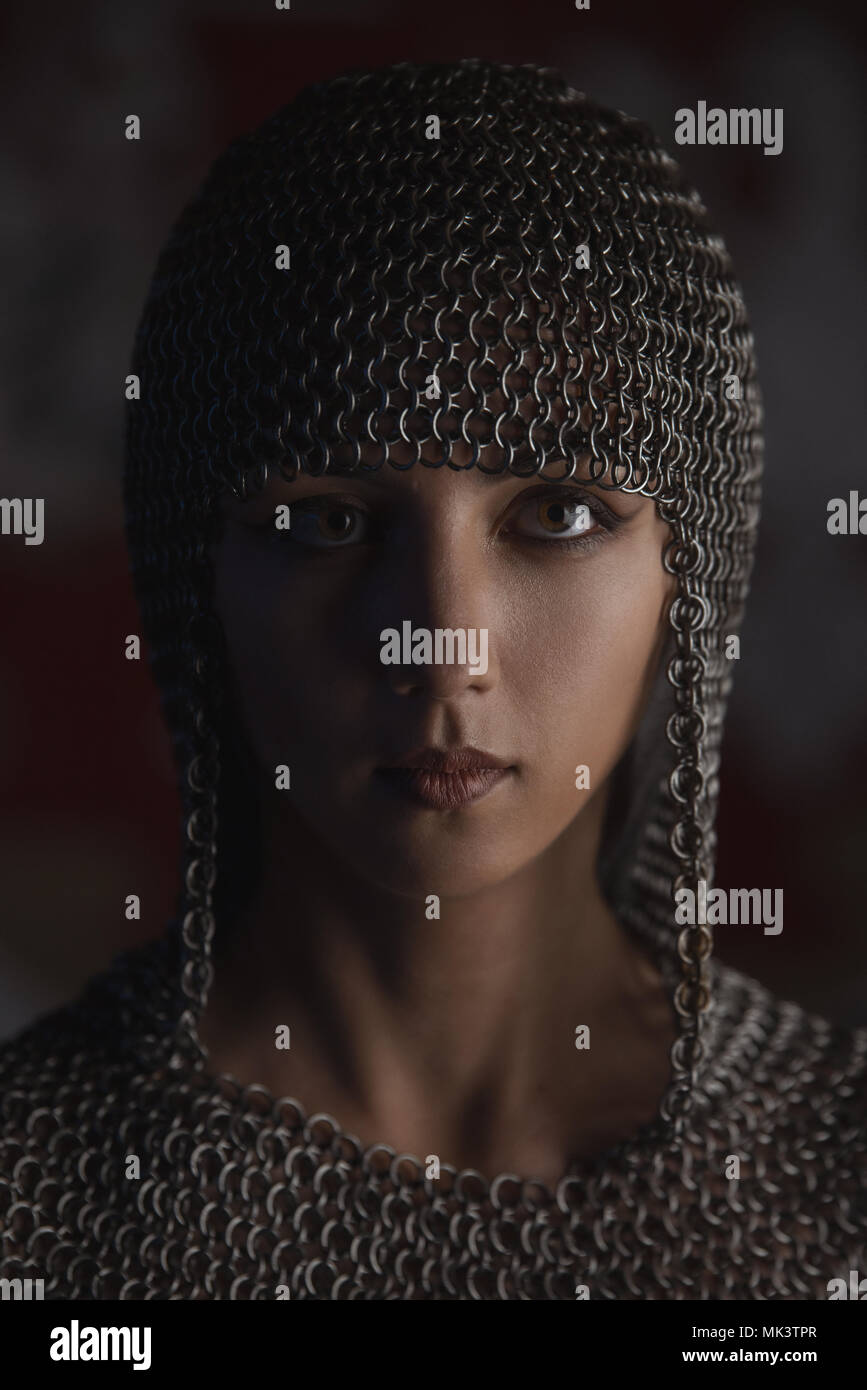 Portrait of beautiful medieval girl warrior in a chainmail hood Stock Photo
