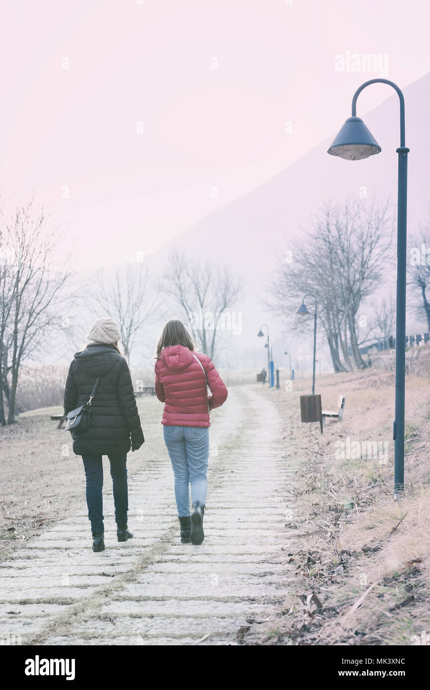 Mother and daughter walking along the lake Endine, Lombardy, Italy Stock Photo