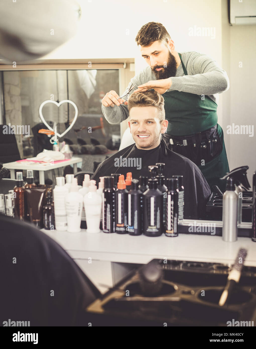Hairdresser Doing New Haircut For Young Smiling Guy Client