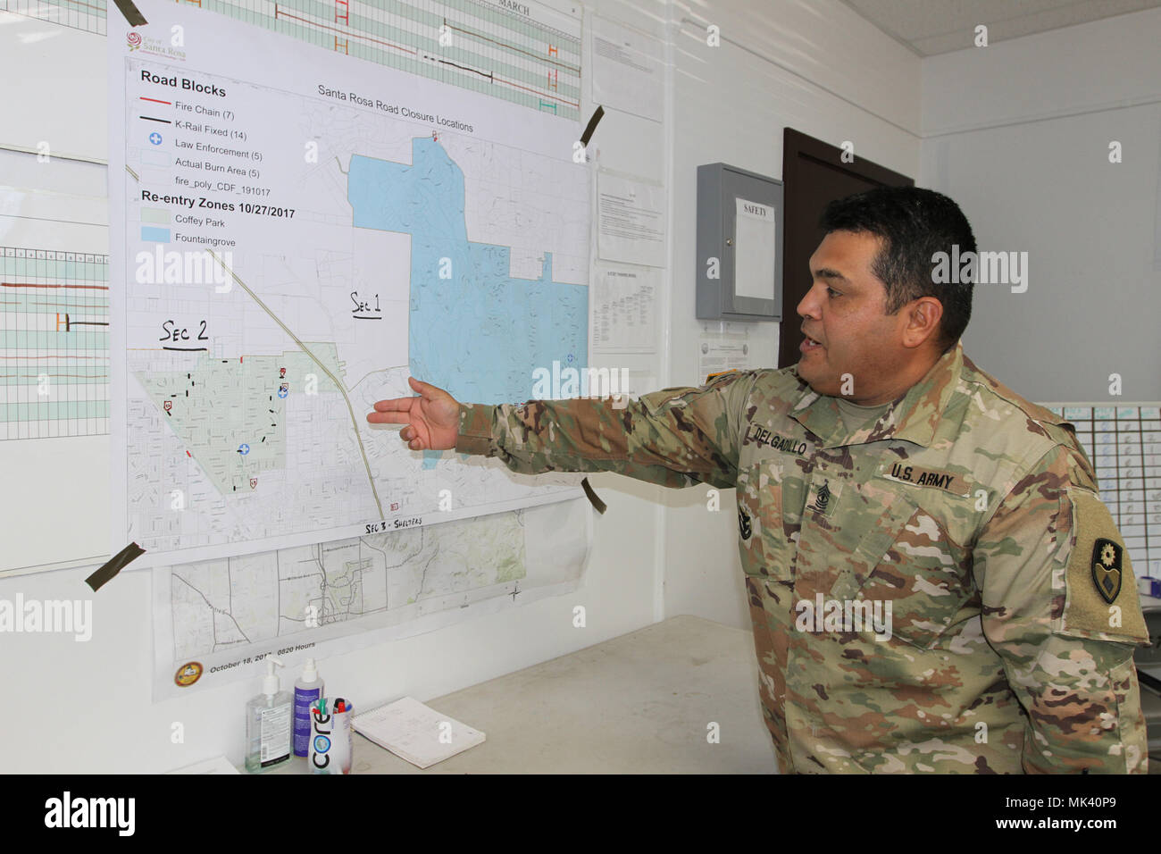 First Sgt. Antonio M. Delgadillo, first sergeant for the 149th CBRN Company, California Army National Guard, maps out the operations plan for checkpoints and road closures Nov. 1 at Santa Rosa, California, as CalGuard continues recovery efforts following the devastating Northern California wildfires. (Army National Guard photo by Staff Sgt Eddie Siguenza) Stock Photo