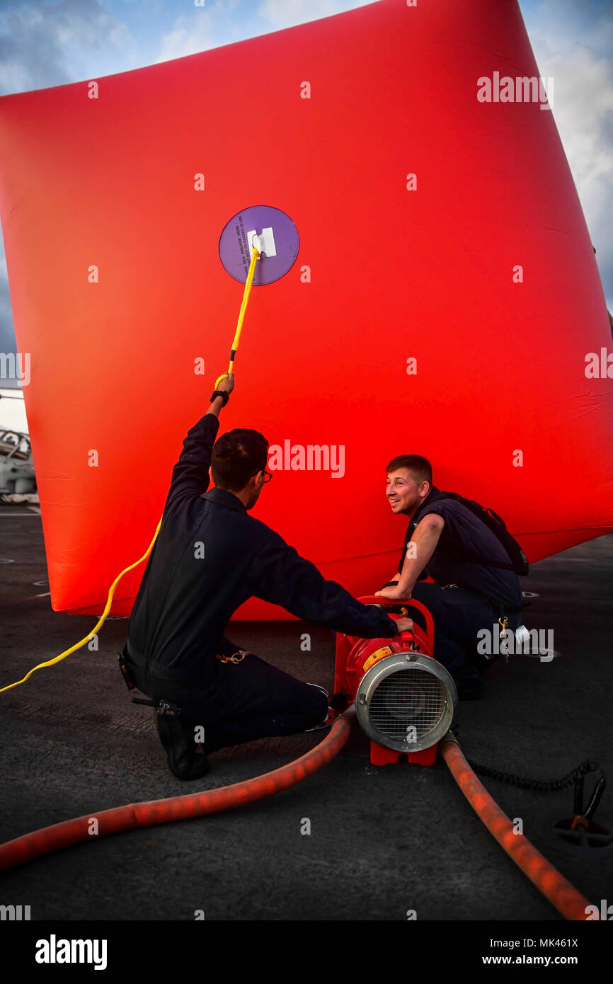 171103-N-BK384-031 MEDITERRANEAN SEA (Nov. 3, 2017) Gunner’s Mate 3rd Class Matthew Bannister, right, from Ellensburg, Washington, and Gunner’s Mate 2nd Class Cristian Peña, from Bloomington, California, fill an inflatable target for a live-fire weapons exercise aboard the San Antonio-class amphibious transport dock ship USS San Diego (LPD 22) Nov. 3, 2017. San Diego is deployed with the America Amphibious Ready Group and the 15th Marine Expeditionary Unit to support maritime security and theater security cooperation in efforts in the U.S. 6th Fleet area of operations. (U.S. Navy photo by Mass Stock Photo