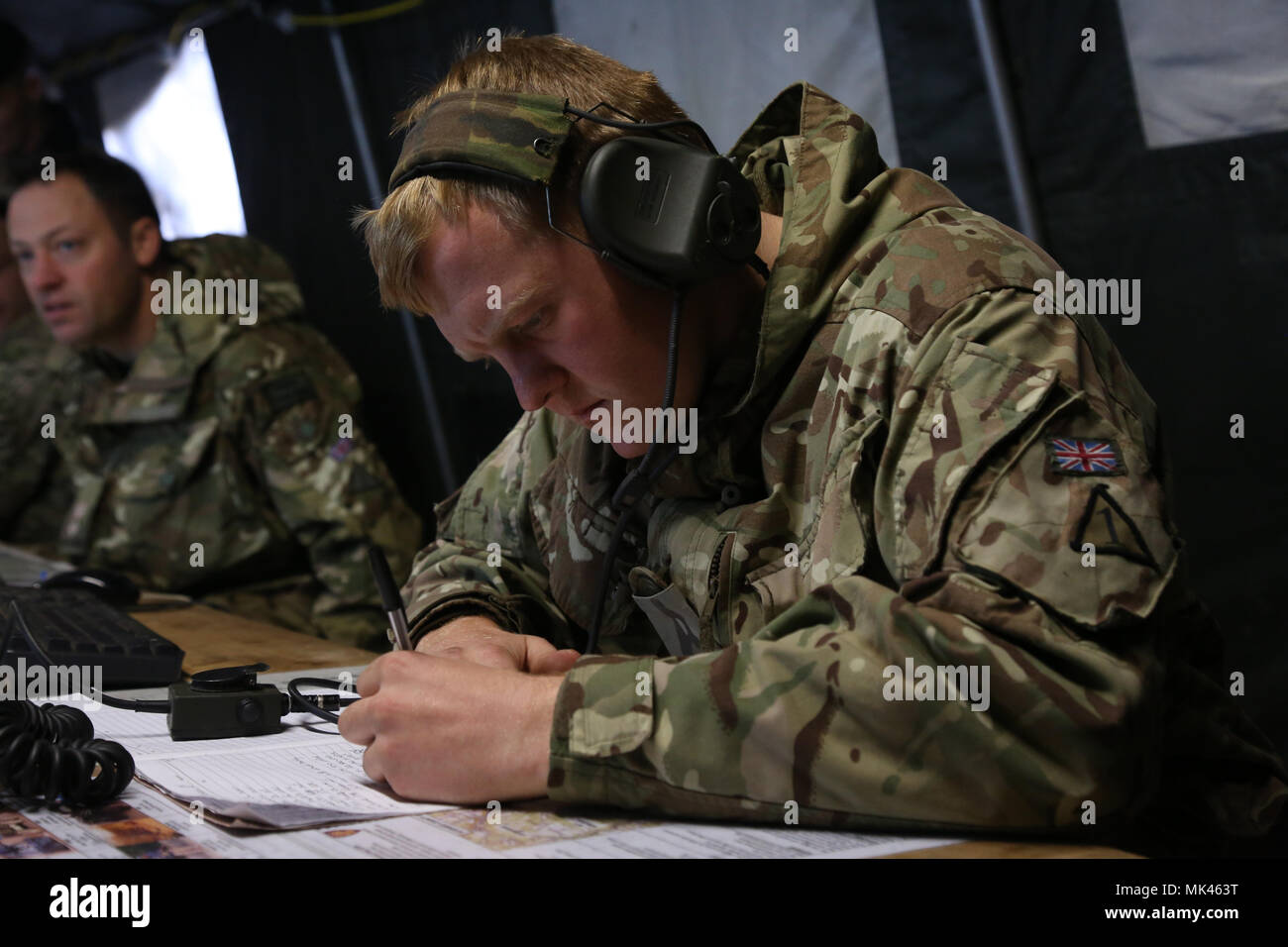 British soldier of the 1st Battalion, Royal Regiment of Fusiliers records mission information while conducting a back brief during exercise Allied Spirit VII at the U.S. Army’s Joint Multinational Readiness Center in Hohenfels, Germany, Nov. 5, 2017. Approximately 4,050 service members from 13 nations are participating in exercise Allied Spirit VII at 7th Army Training Command’s Hohenfels Training Area, Germany, Oct. 30 to Nov. 22, 2017. Allied Spirit is a U.S. Army Europe-directed, 7ATC-conducted multinational exercise series designed to develop and enhance NATO and key partner’s interoperabi Stock Photo