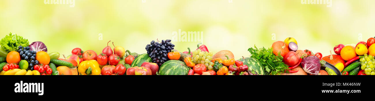 Panoramic collection fresh fruits and vegetables on yellow background. Free space for text. Stock Photo