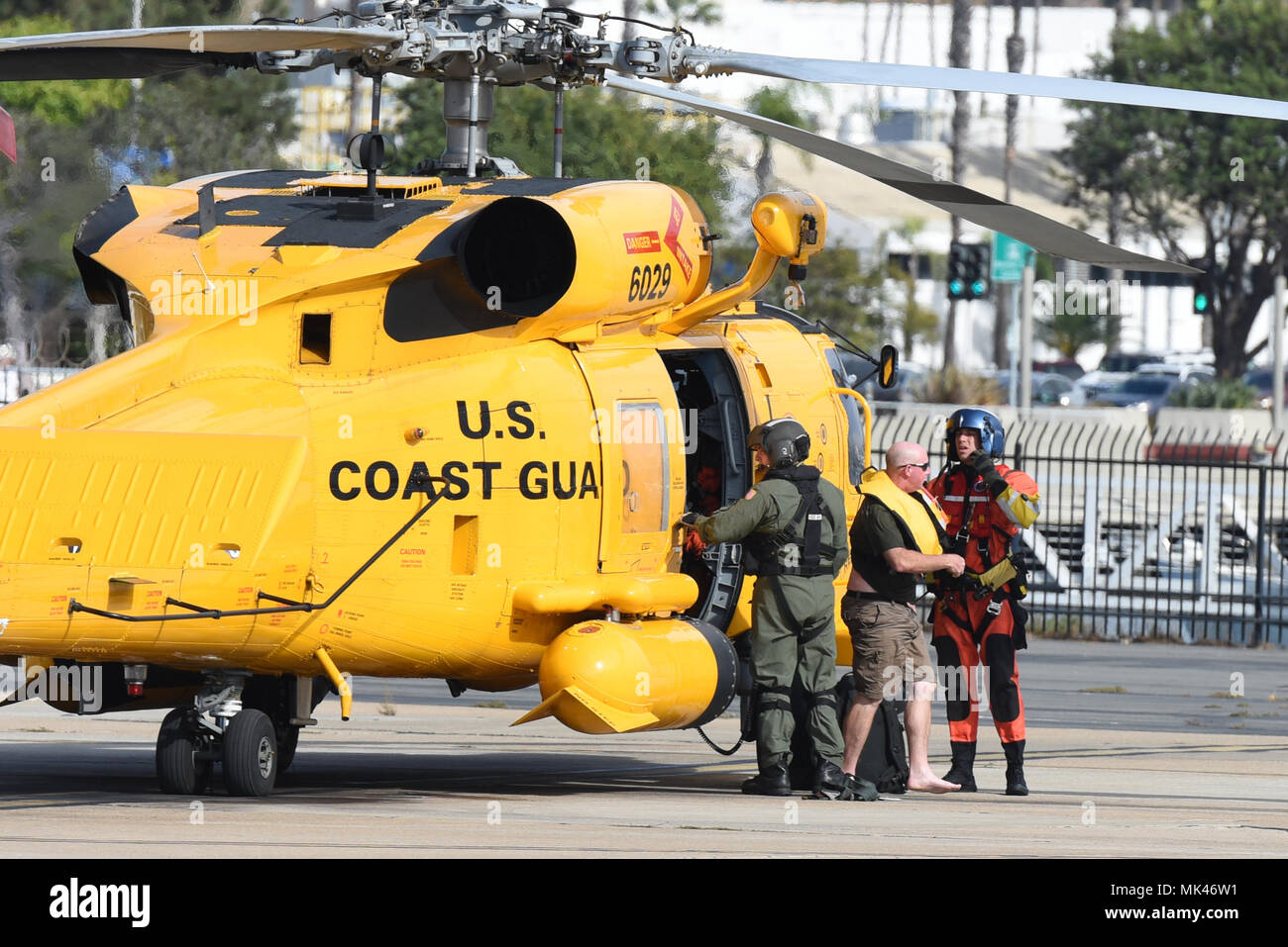 A boater is helped off of a Coast Guard Sector San Diego MH-60T Jayhawk helicopter by the crew at Coast Guard Sector San Diego November 6, 2017. The man was rescued after his 18-foot cuddy cabin boat began taking on water 12 miles west of San Onofre State Beach, San Clemente, California. (U.S. Coast Guard photo by Petty Officer 2nd Class Joel Guzman/released) Stock Photo