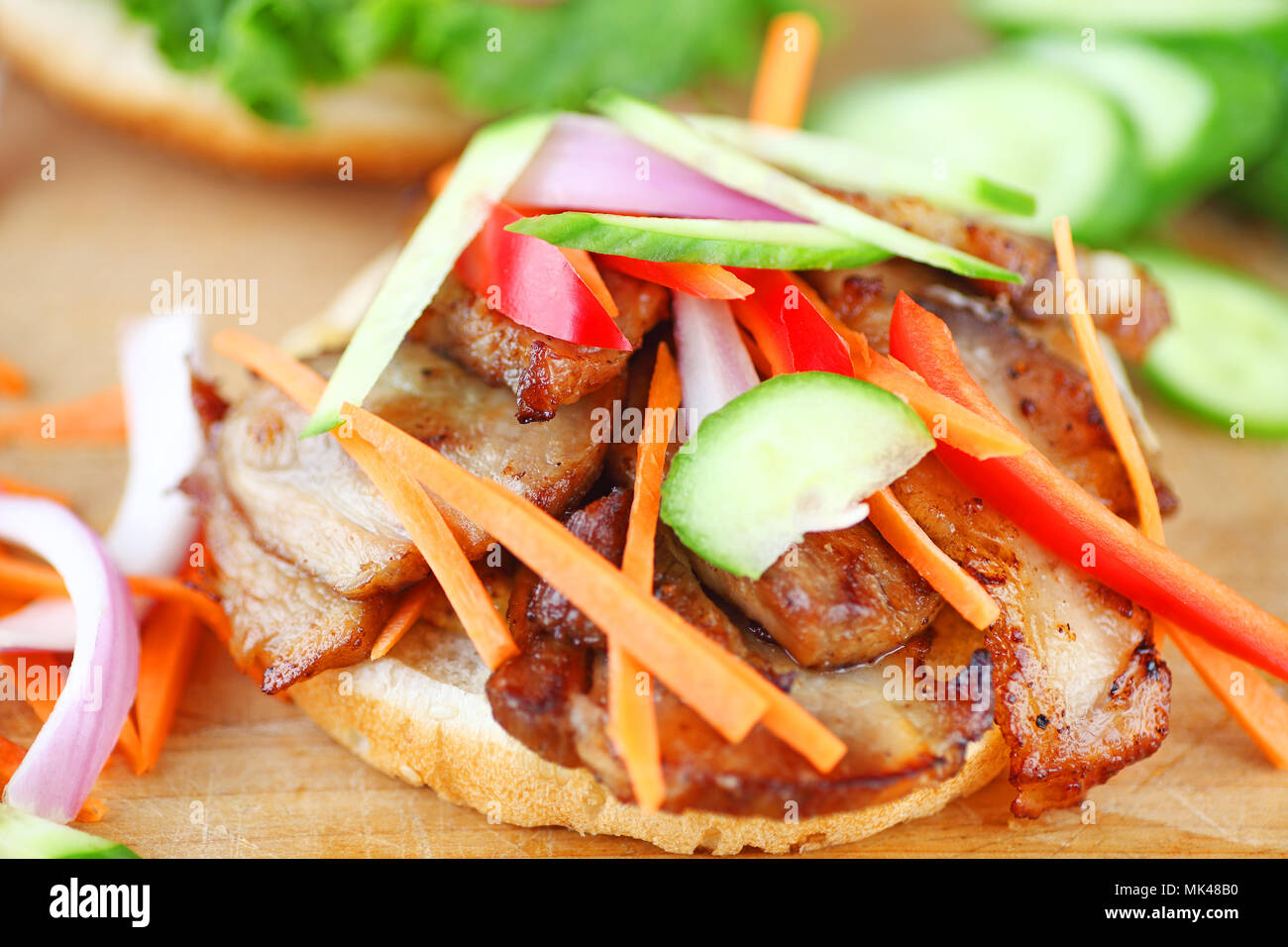 roast pork slices with raw cucumber, bell pepper, onion and carrot on