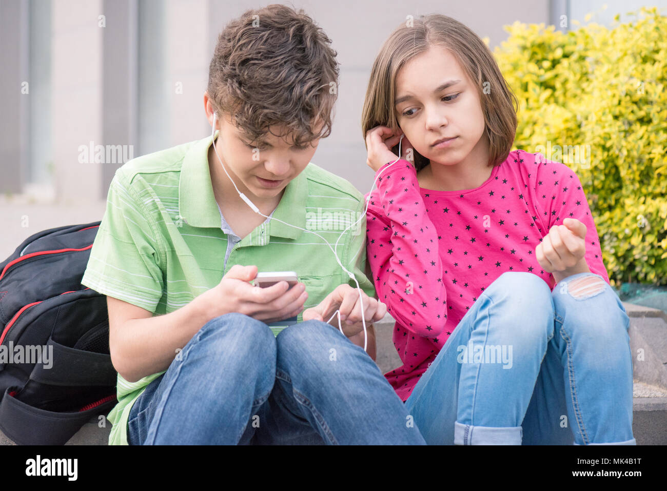 Teen boy and girl with headphones Stock Photo