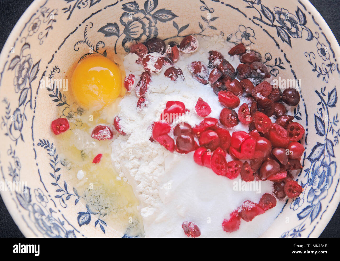 Ingredients for making cranberry scones in decorative mixing bowl Stock Photo