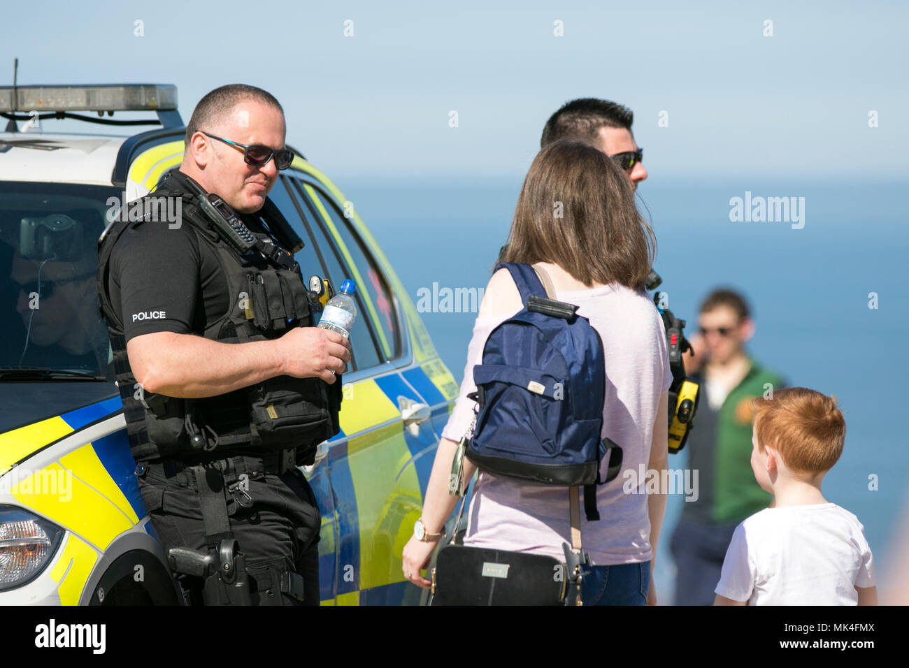 armed police interacting with the general public on the promenade on