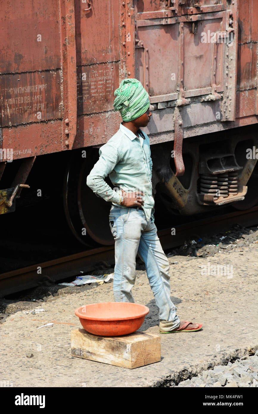 A railway worker standing between the tracks, india Stock Photo