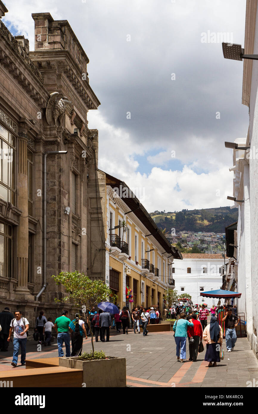 QUITO, ECUADOR - OCTOBER 27, 2015: People walking down a street lined with colonial buildings in the historic Old Town Stock Photo
