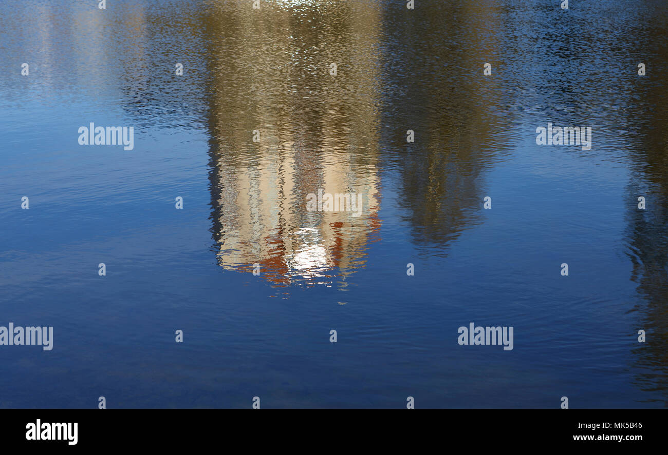 Abstract reflection of a colorful houses in water. City life concept. Stock Photo