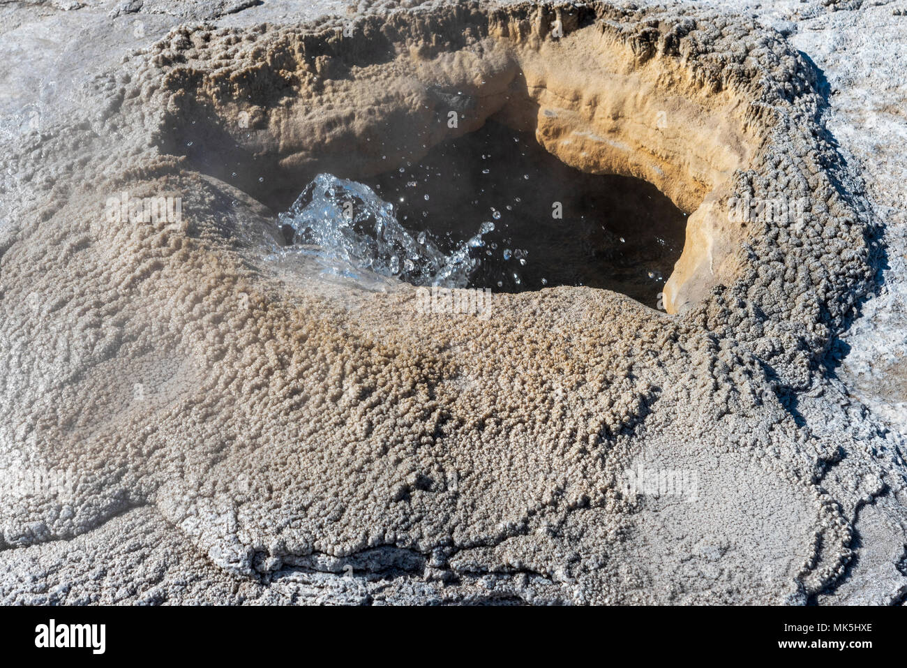 Bubbling hot spring surrounded by mud. Stock Photo
