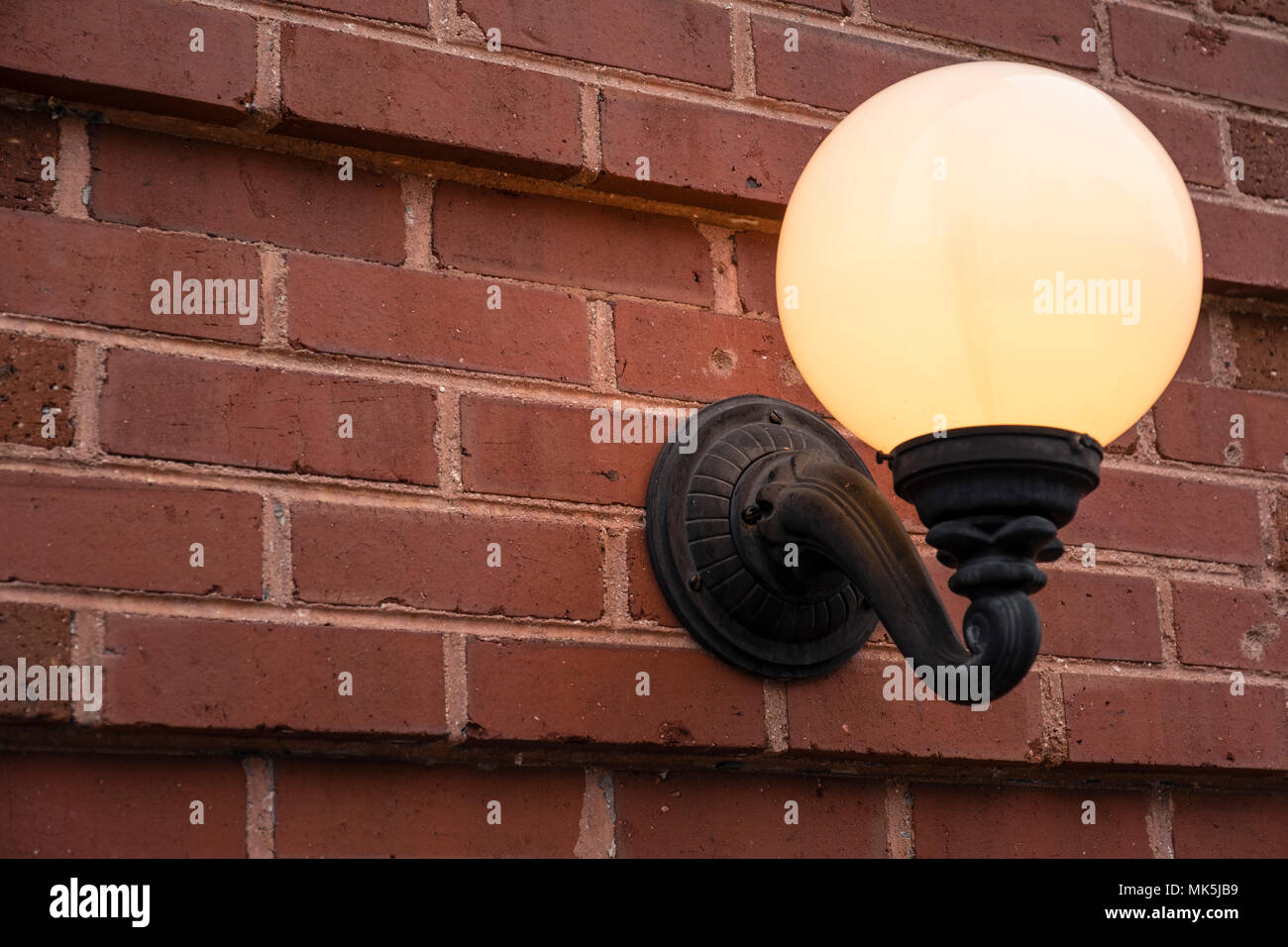 globe light on brick wall illuminated warm glow Stock Photo