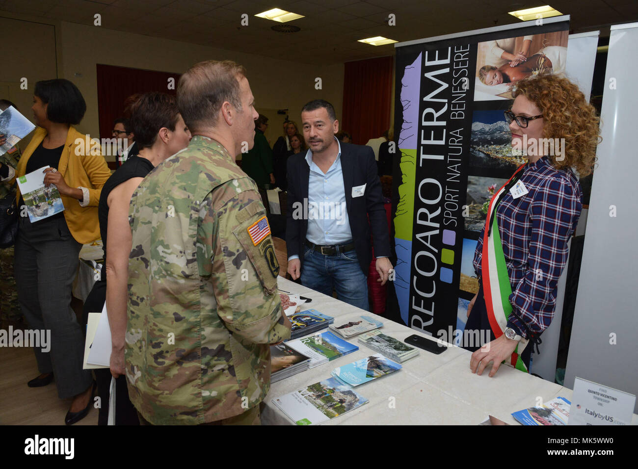 U.S. Col. Eric M. Berdy, U.S. Army Garrison Italy commander, speaks with Lisa Storti, councilwoman of Recoaro Terme, during the Meet the Mayors event at the Golden Lion Conference Center on Caserma Ederle, Vicenza, Italy, Nov. 8, 2017.   The event is an informal fair that hosts mayors, council members, and cultural and tourism representatives from Italian townships in the Vicenza and Padova provinces. (U.S. Army Photo by Paolo Bovo) Stock Photo