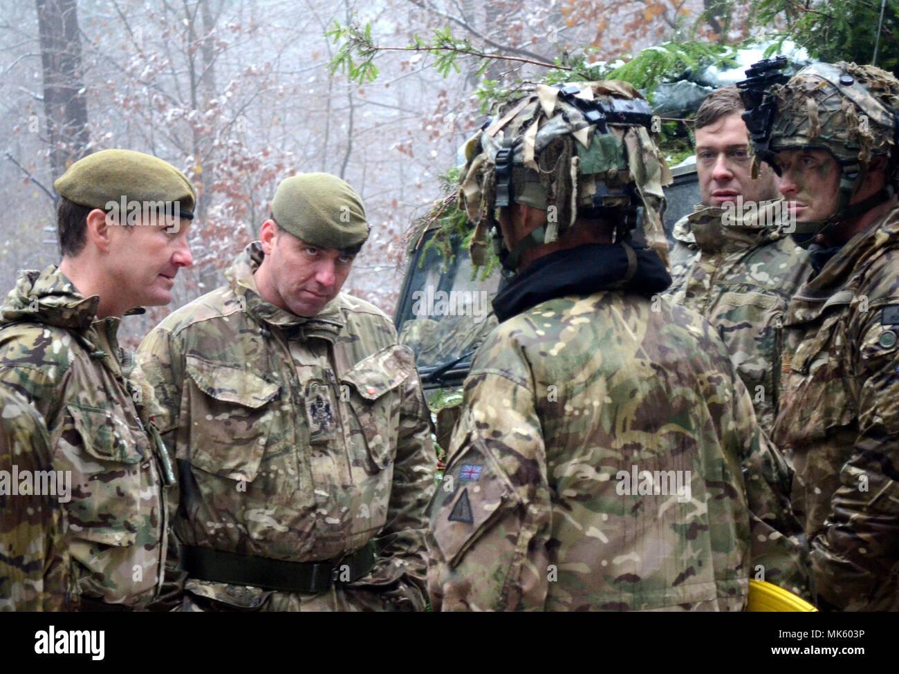 Despite the snow, Brig. Gen. Zac Stenning (Lft), Commander, 1st Mechanized Brigade, British Army, stops by to visit with British soldiers with the 1st Battalion, Royal Regiment of the Fusiliers training at the U.S. Army's Joint Multinational Readiness Center in Hohenfels, Germany, as they participate in Allied Spirit VII, 12 Nov. 2017. Approximately 4,050 service members from 13 nations are participating in exercise Allied Spirit VII at 7th Army Training Command’s Hohenfels Training Area, Germany, Oct. 30 to Nov. 22, 2017. Allied Spirit is a U.S. Army Europe-directed, 7ATC-conducted multinatio Stock Photo