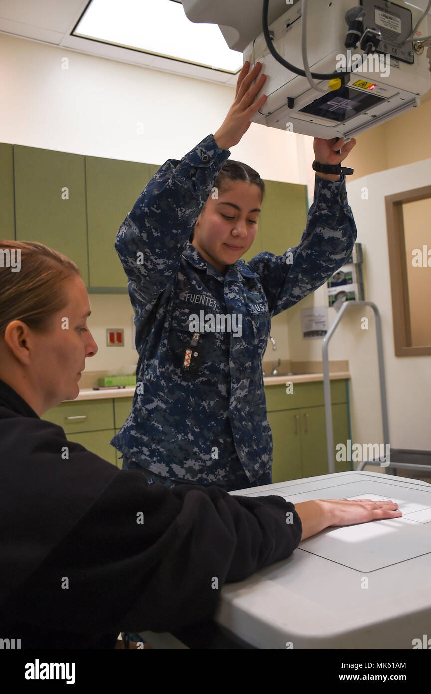 171102-N-NR998-007 BREMERTON, Wash.  Hospital Corpsman Seaman Daisy Fuentes from Pasadena, Calif., prepares to take and X-ray image of a patient's hand at Naval Hospital Bremerton. (U.S. Navy Photo by Mass Communication 1st Class Gretchen M. Albrecht/ Released) Stock Photo