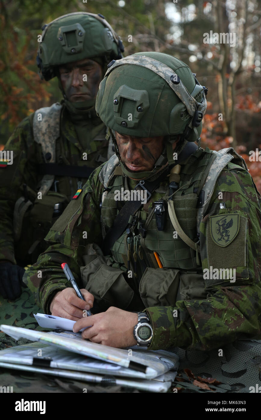 Lithuanian army Capt. Ilgaydas Vidas of the Lithuanian Griffin Brigade records mission information while conducting battle circulations during exercise Allied Spirit VII at the U.S. Army’s Joint Multinational Readiness Center in Hohenfels, Germany, Nov. 13, 2017. Approximately 4,050 service members from 13 nations are participating in exercise Allied Spirit VII at 7th Army Training Command’s Hohenfels Training Area, Germany, Oct. 30 to Nov. 22, 2017. Allied Spirit is a U.S. Army Europe-directed, 7ATC-conducted multinational exercise series designed to develop and enhance NATO and key partner’s Stock Photo