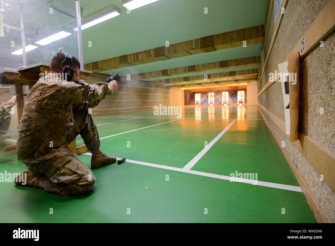 A cartridge can be seen flying from an M9 Pistol as U.S. Soldiers with
