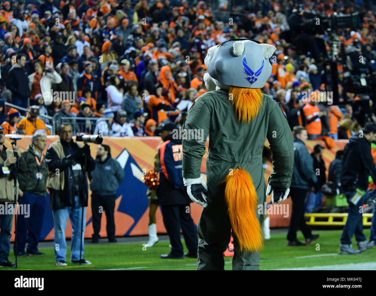 Miles, the Denver Broncos’ mascot, pumps up the crowd in his Air Force flight suit during the a Salute to Service game Nov. 12, 2017, at Sports Authority Stadium at Mile High in Denver. Miles wore a 120th Fighter Squadron patch on his left shoulder in support of the U.S. military. (U.S. Air Force photo by Airman 1st Class Holden S. Faul/ Released) Stock Photo