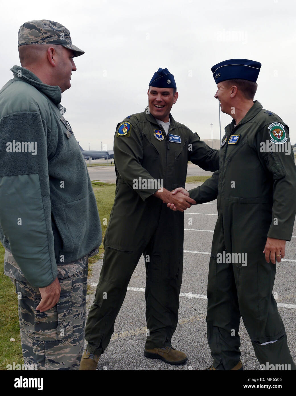 Lt. Col. Patrick McClintock (center), 502nd Operations Support Squadron commander, greets Maj. Gen. Patrick Doherty, 19th Air Force commander, during his stop at Lackland’s air traffic control tower, Kelly Field Annex, Nov. 8, 2017. The general took time to visit various work environments to interact with members of the JBSA community and listen to their feedback. (Air National Guard photo by Tech. Sgt. Mindy Bloem)  Stock Photo