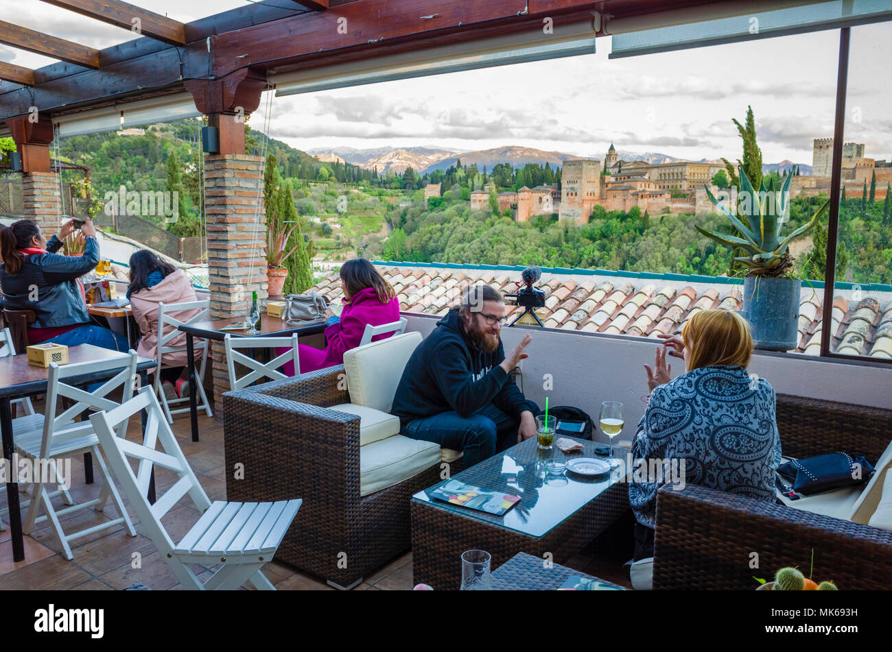 Granada, Spain: Tourists at El Balcón de San Nicolás cafe and restaurant in the Albaicin district old town, enjoy a panoramic view of the Unesco liste Stock Photo