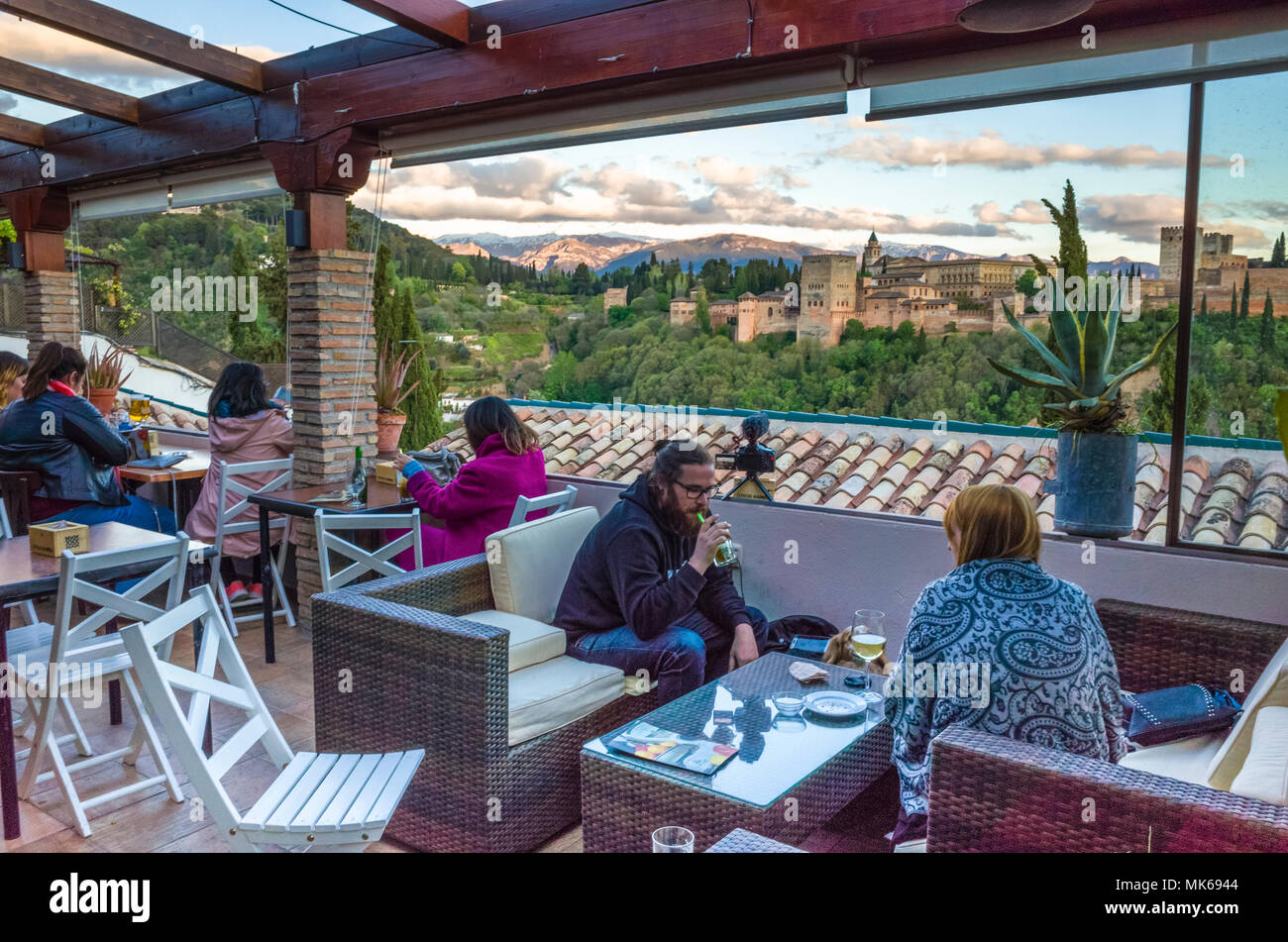 Granada, Spain: Tourists at El Balcón de San Nicolás cafe and restaurant in the Albaicin district old town, enjoy a panoramic view of the Unesco liste Stock Photo
