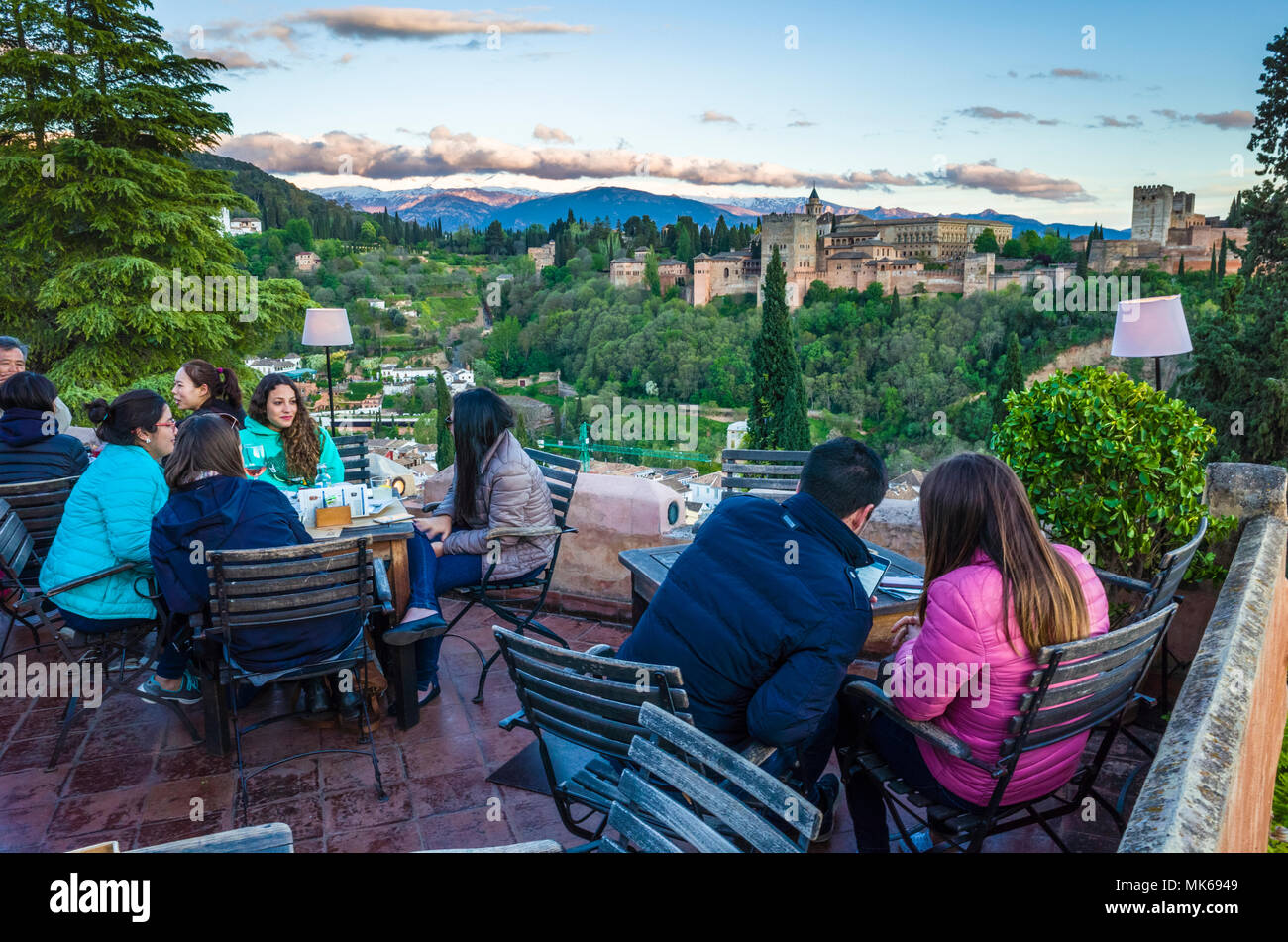 Granada, Andalusia, Spain - April 29th, 2018 : Tourists at Huerto de Juan Ranas cafe and restaurant in the Albaicin district old town, enjoy a panoram Stock Photo