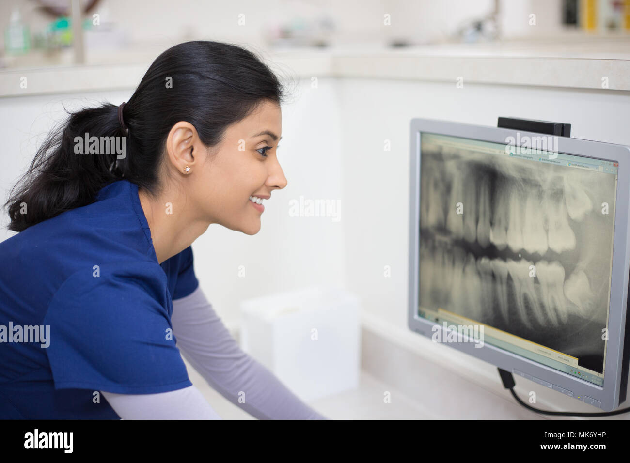 Closeup portrait of allied health dental professional in blue scrubs