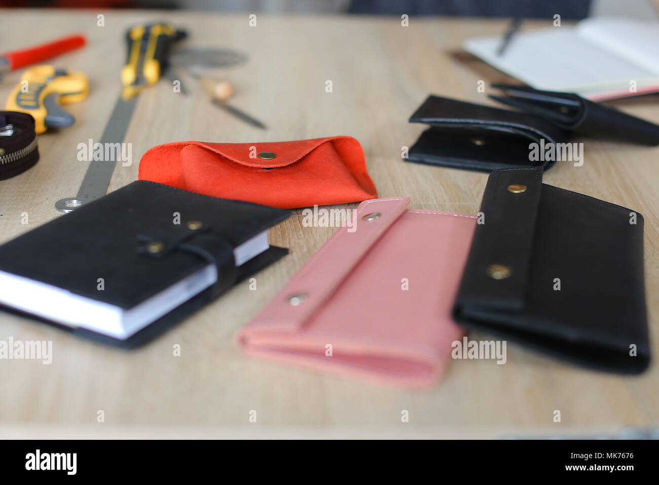 Handmade leather wallets and notebook on table at atelier Stock Photo ...