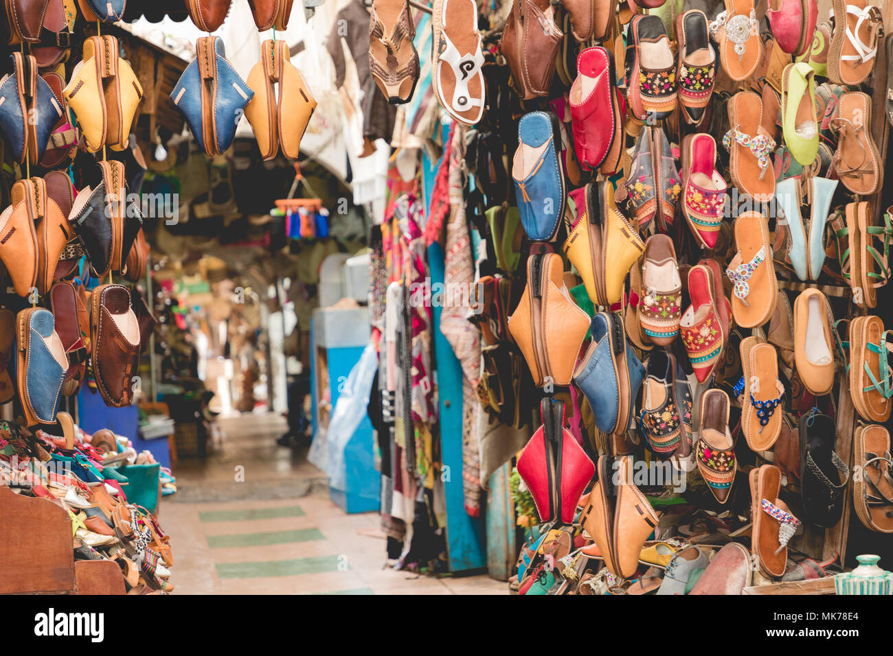 Moroccan leather goods bags and slippers at outdoor market in Marrakesh