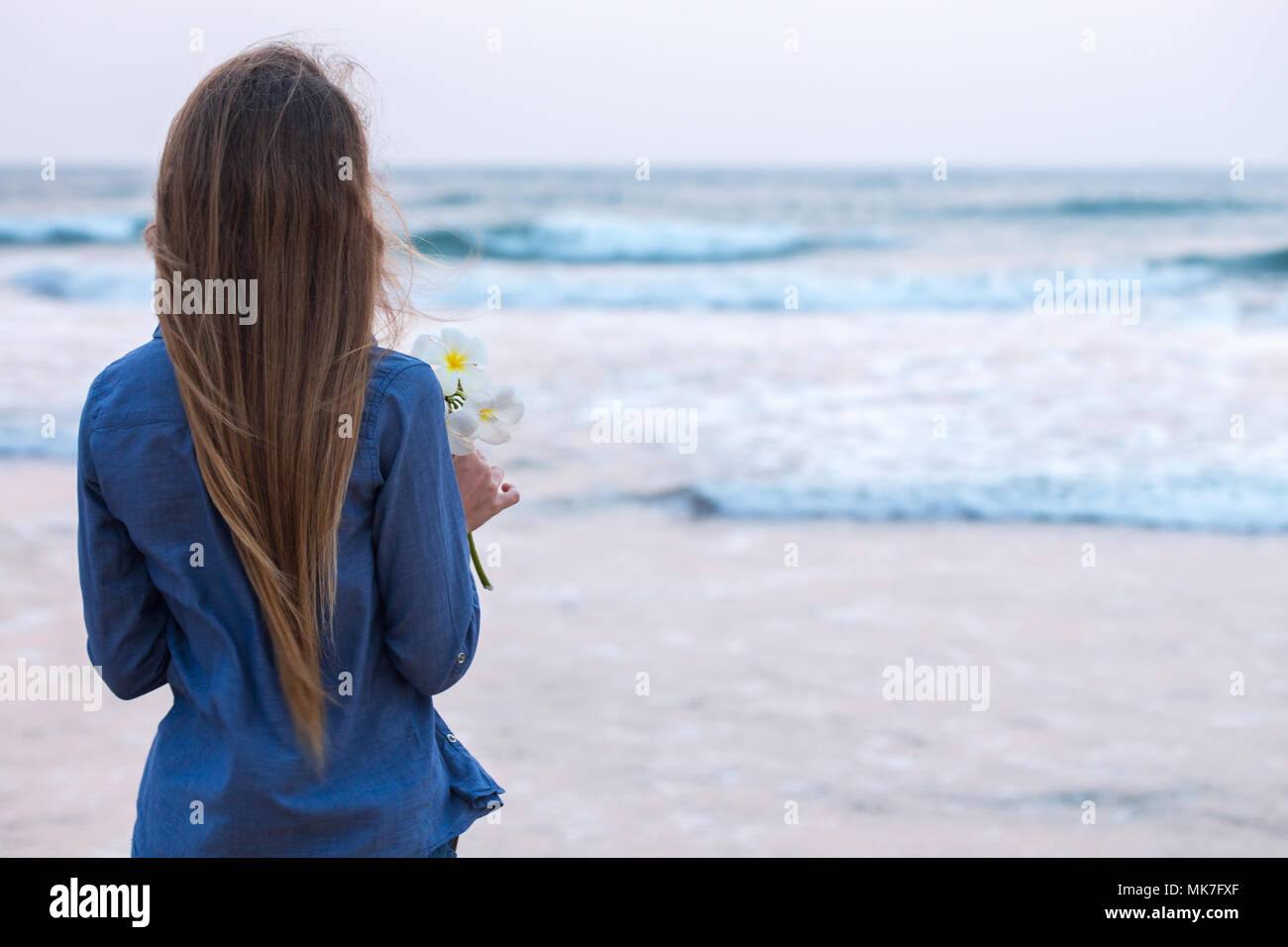 A girl by the ocean at sunset Stock Photo - Alamy
